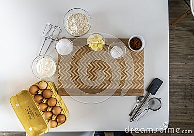 Top view of kitchen equipment with flour, cocoa powd, eggs, and butter for baking a cake Stock Photo