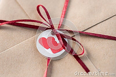 Top view of kraft envelope with tag with two hearts and ribbon Stock Photo