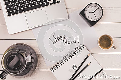 Top view of laptop, clock, coffee and inscription work hard Stock Photo