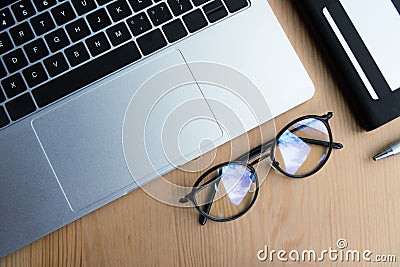 top view of laptop eyeglasses notebook pen and credit card Stock Photo