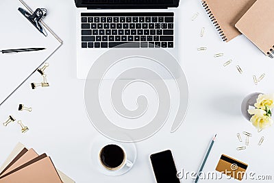 View of laptop, smartphone with blank screen, clipboard, notebooks, cup of coffee, craft paper, credit card, binder Stock Photo