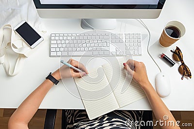 Top view of left handed business woman in minimalistic office. O Stock Photo