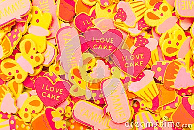 Top view of lots of candy-coloured foam stickers depicting hearts, butterflies and cupcakes. Summer or joy concept Stock Photo