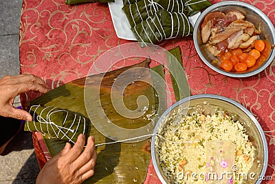 madam just finished wrapping the traditional Chinese ZongZi for Dragon Boat Festival ie DuanWu festival Stock Photo