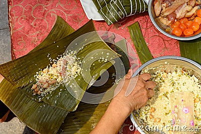 madam making traditional Chinese ZongZi for Dragon Boat Festival ie DuanWu festival Stock Photo