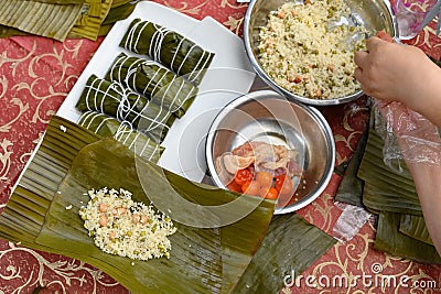 madam making traditional Chinese ZongZi for Dragon Boat Festival ie DuanWu festival Stock Photo