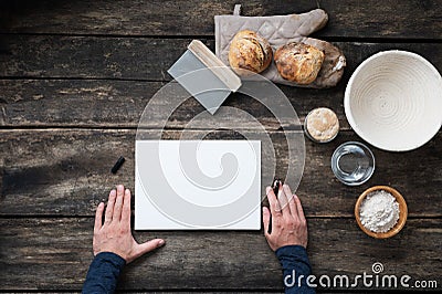 Top view of male hands about to write a recipe for a homemade healthy sourdough bread Stock Photo