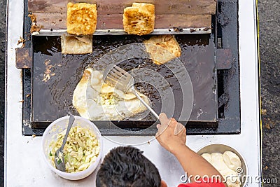 Top view of a man hand cooking martabak jawa Editorial Stock Photo