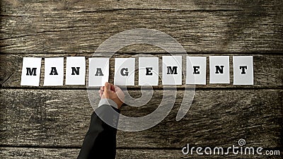 Top view of manager hand arranging ten white cards with letters Stock Photo