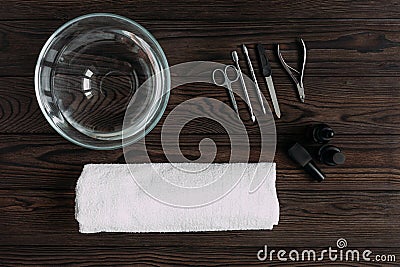 Top view of manicure tools on wooden table. Cuticle clippers, manicure scissors, Ñuticle pusher, manicure stick, emery board. Stock Photo