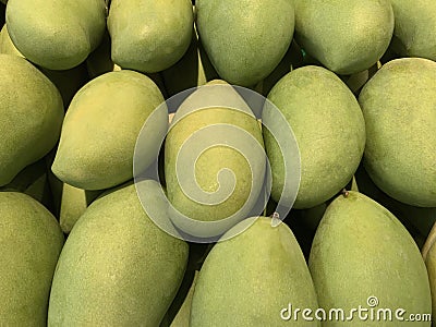 Top view of many fresh mangos in the supermarket. Green mango background of Thailand Stock Photo