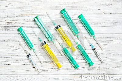 Top view of many syringes prepared for injection at wooden background. Treatment concept with copy space Stock Photo