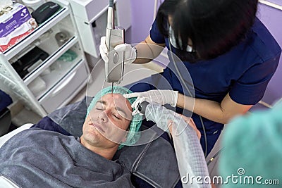 Patient receiving a laser treatment to rejuvenate the skin Stock Photo