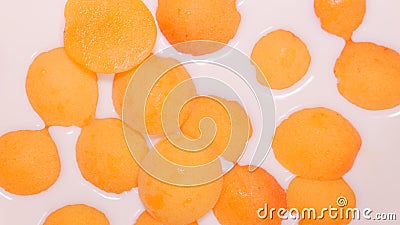 TOP VIEW: Milk fills ripe apricots Stock Photo