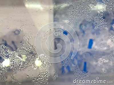 Top view of Mirror glass the dump ice bucket with water steam bubble drop wet condensation Stock Photo