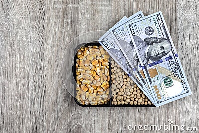 Top view mockup of 100 dollar banknotes and samples of soybean and corn seeds Stock Photo