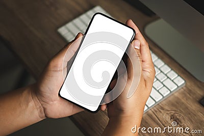 Top view Mockup image hand using a smartphone man Holding Cell Phone With Blank Screen Stock Photo