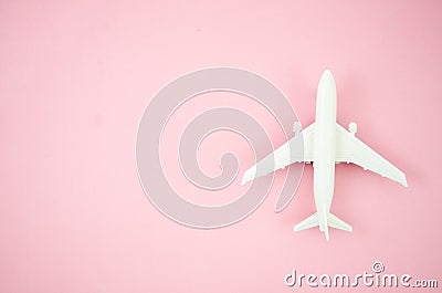 Top view model plane, airplane toy on pink pastel background. Flat lay with copy space for travel banner Stock Photo