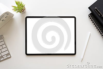 Top view of modern workspace white desk with blank screen tablet computer and office equipment. Table with copy space for business Stock Photo