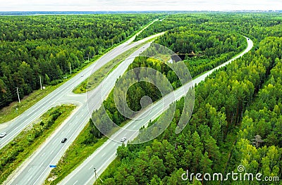 Top view of movement of cars on motorway through the forest Stock Photo