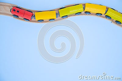 Top view on multicolor kids toy train cars bricks on wooden railway blue background. Copyspase. flat lay. Children toys on the Stock Photo