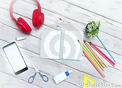 Top view musical overhead headphones with blocktone for text. Home office with pencils. Scissors. Copy space. Office. Desktop. Stock Photo