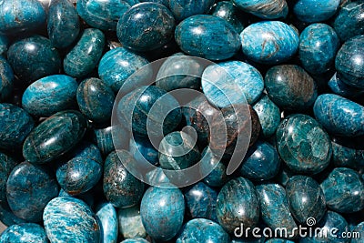 Top view of natural tumbled Apatite Stone pile under the light Stock Photo
