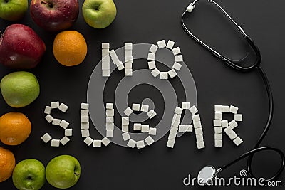 Top view of no sugar phrase made of sugar cubes with stethoscope and fruits Stock Photo