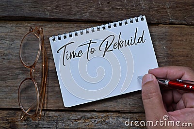 Notebook written with text TIME TO REBUILD. Top view Stock Photo