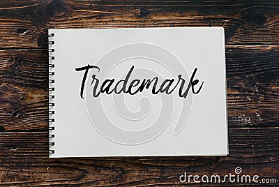 Top view of notebook written with Trademark on wooden background Stock Photo