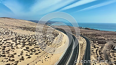 Top view od a curvy road across the sandy dunes of Fuerteventura islands. Stock Photo