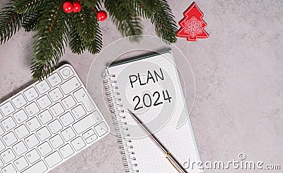 top view of the office desk. Notepad and lettering plan for 2024. Plans and goals for the new year Stock Photo