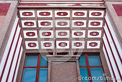 A top view of an old building with interesting architecture. TIles on top and blue windows are on the front. Avant-garde style Stock Photo