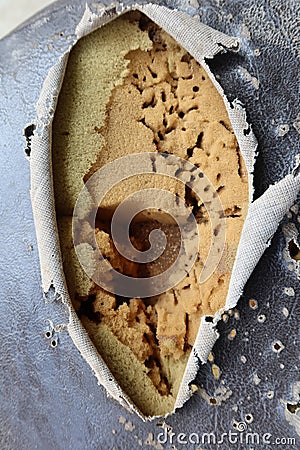 Top view of old motorcycle seat surface, torn leather seats, visible sponge image for vintage background. Stock Photo