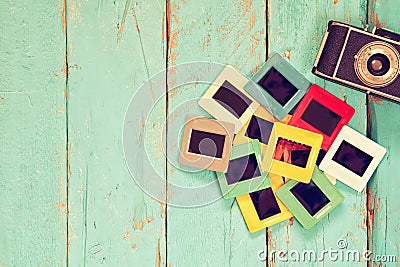 Top view of old slides frames over wooden background Stock Photo