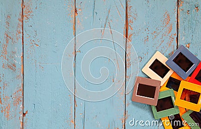 Top view of old slides frames over wooden background Stock Photo