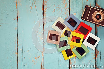 Top view of old slides frames over wooden background Stock Photo