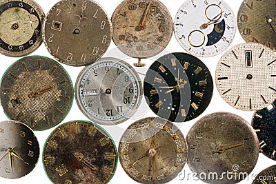 Top view on old worn clock dials on white isolated studio background. Aged scratched round watch faces with hands and Stock Photo