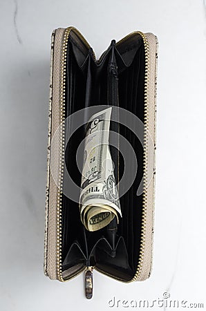 Top view of opened female purse and cash in it on the white surface.Vertical image Stock Photo