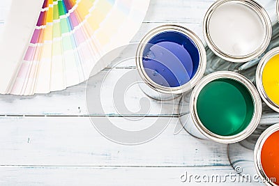 Top of view paint cans brushes and color palette on table Stock Photo