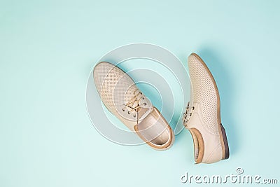 Top view of a pair of light summer men`s shoes on a light blue background. Stock Photo