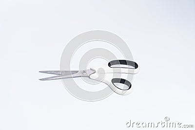 Top view of a pair of white color plastic open scissors Stock Photo