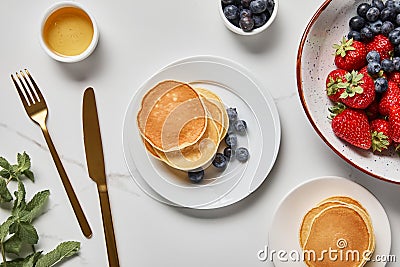 Top view of pancakes, honey, blueberries Stock Photo