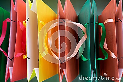 Top view of Paper shopping bags with handles on green background. Stock Photo