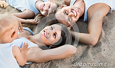 Top view on parents with kids relaxing on beach Stock Photo