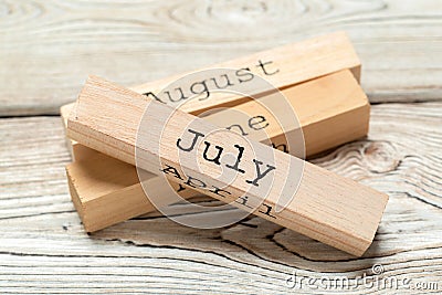 Top view of parts of wooden calendar on dark wooden tabletop Stock Photo