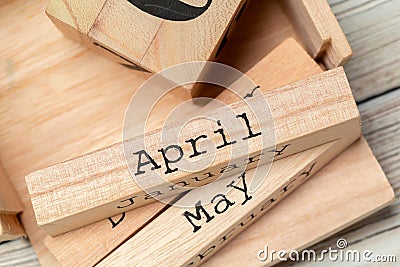 Top view of parts of wooden calendar on dark wooden tabletop Stock Photo