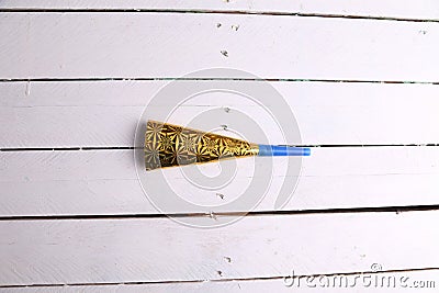 Top view of a party noisemaker isolated on a white wooden surface Stock Photo