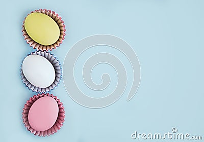 Top view pastel colors eggs row on a blue background Stock Photo