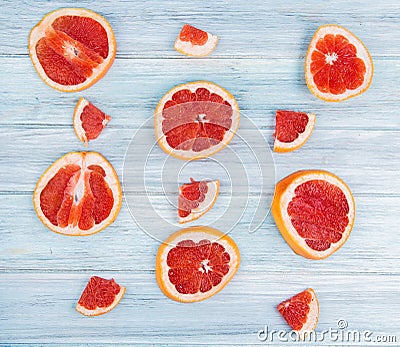 top view of pattern of sliced grapefruits on wooden background Stock Photo